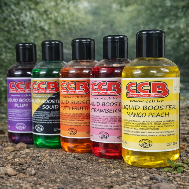 CCB Carp Cro Baits Liquid Booster tekući dipovi u prirodnom okruženju uz vodu, različite arome uključujući Mango Peach, Squid, Tutti Frutti i Strawberry, namijenjeni pojačavanju atraktivnosti šaranskih mamaca.